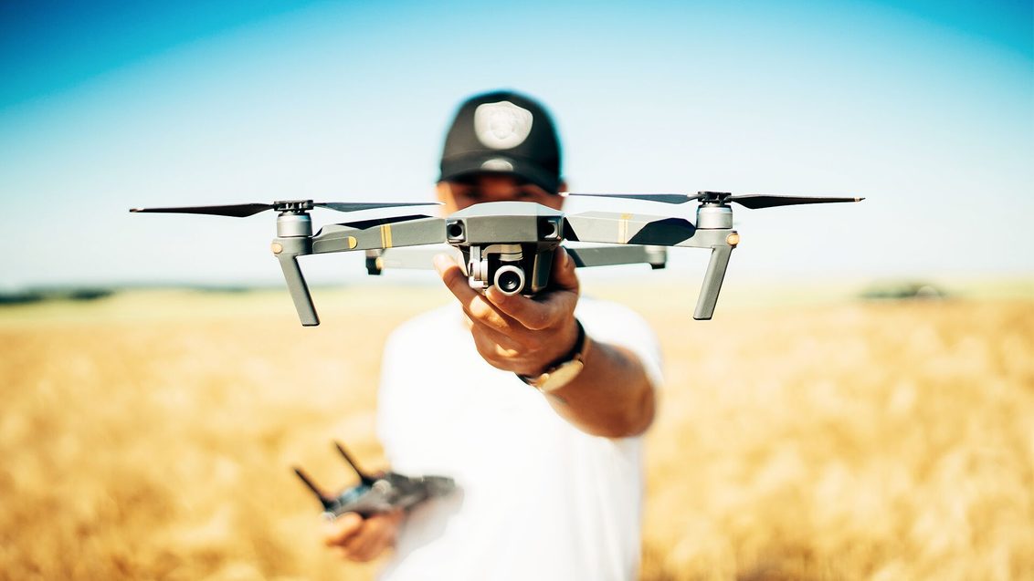 field_drone_with_camera_held_by_grower_in_field